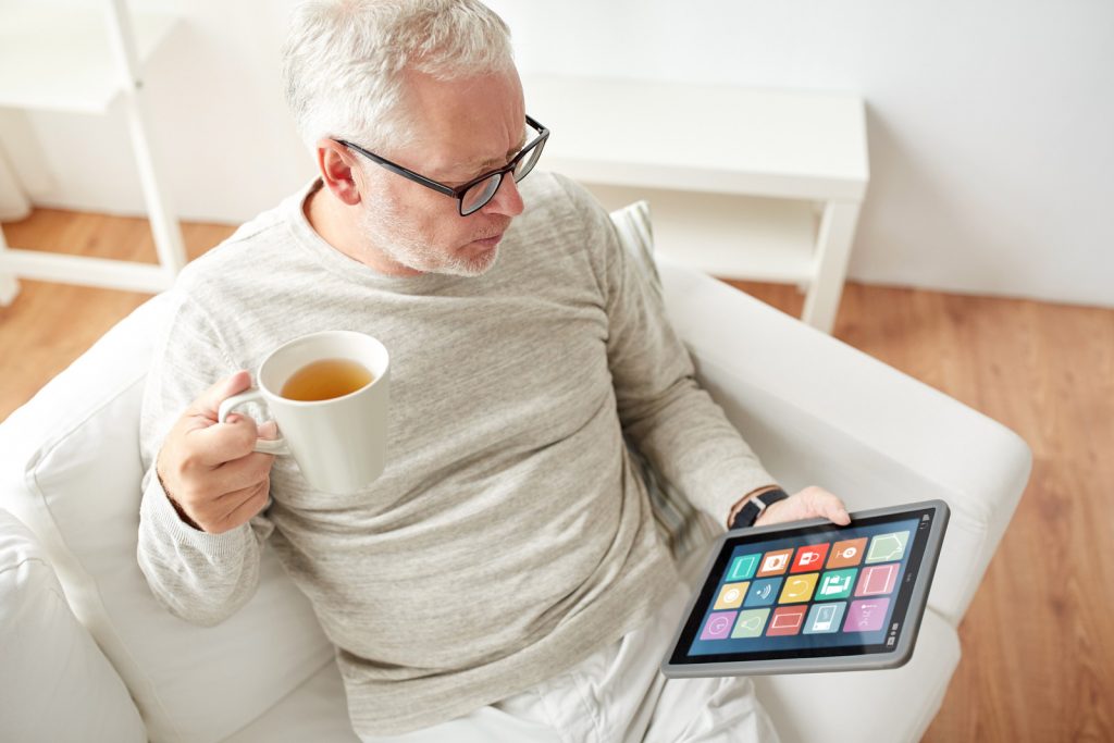 old man with looking at tablet