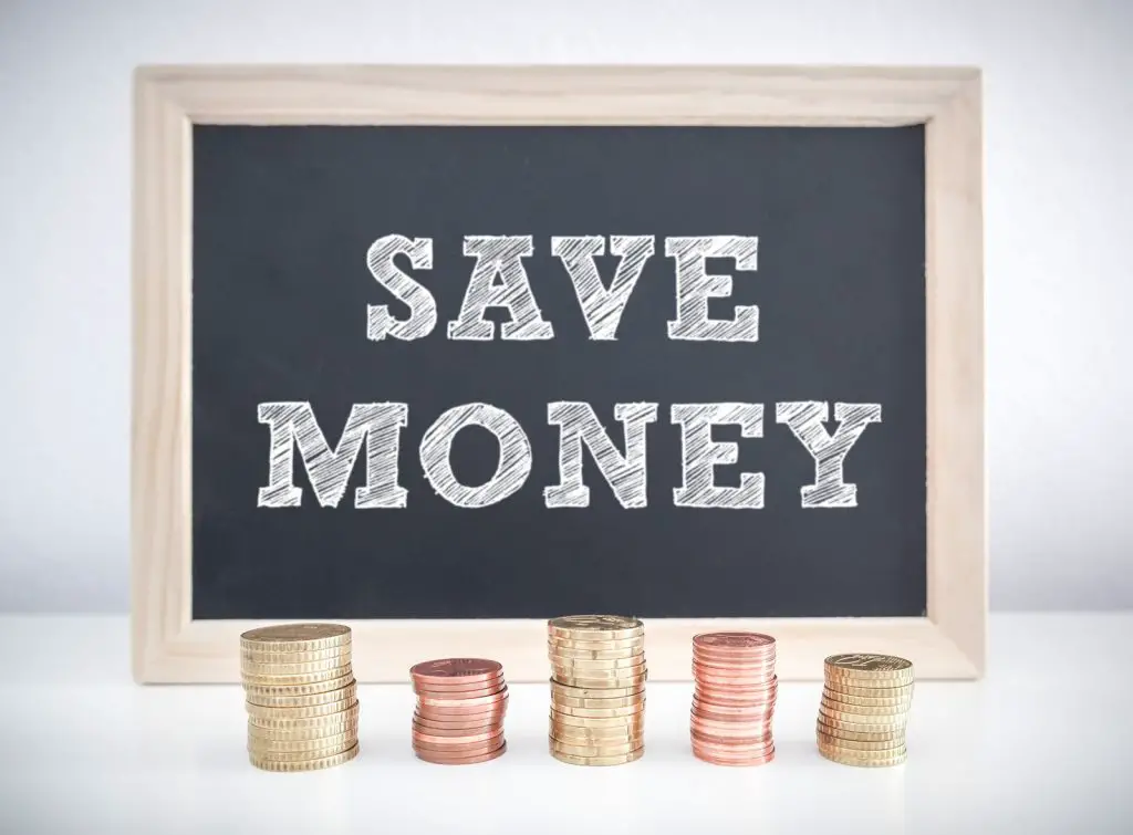 image showing stack of coins with save money sign above