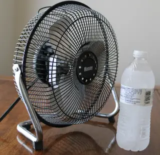 frozen water bottle in front of fan