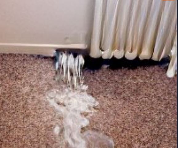 image of a burst radiator leaking water into the room