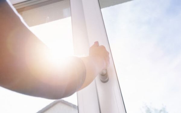 image of person opening double glazing window
