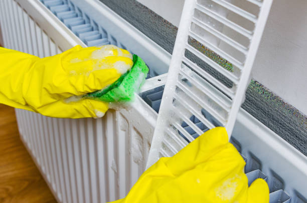 cleaning a gas heater with a washcloth and soap suds at home